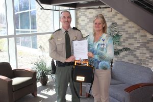 Reserve Deputy Mark A. Roorda presenting a Thank You letter to PRHC’s Material Manager Julie Flaig for their generous gift. 