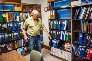 Don DeBoef points out reference materials only available at the Keo-Mah Genealogy Society Library.
