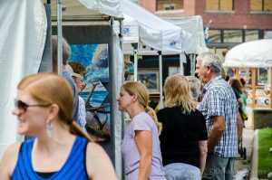 Many people braved the early rain and the heat to browse the creative work at Art on the Square Saturday.