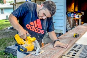 Levi Ritz seen here working on a custom flag being made out of the wood from an old barn.
