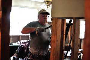 New Sharon Fire Chief Steve Gerard works on clearing flood soaked material from a home in Baton Rouge.