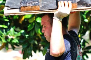 New Sharon Fire's Josh Crouse struggles with this large piece of flooring ripped out of a flood damaged home.