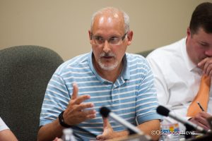 Oskaloosa School Board Member Kraig Van Hulzen gets into a heated discussion with fellow board member Carl Drost on Tuesday night.