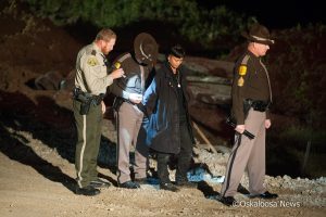 A person is taken into custody at the Dakota Access Pipeline site along the Skunk River in Mahaska County on Monday night.