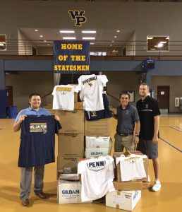 Joe Reagan, Nik Rule, and Blake Sandquist pose with the first shipment of clothing headed to Houston.