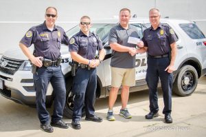 Mark Willett (middle right) presented checks totaling $20,000.00 to the Oskaloosa Police Department for the K9 program.