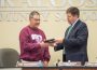 Former Oskaloosa School Board member and president Tom Richardson receives a plaque recognizing his years of service to the district.