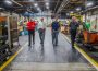Mark Willett (left) and Congressman Dave Loebsack (left center) converse during a tour of the CLOW facility in Oskaloosa.