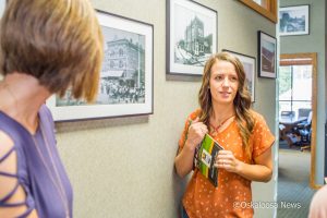 Oskaloosa Main Street Director Emily Brown talks about Oskaloosa history with guests at an open house in her honor this past week.