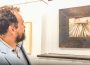 Brant Bollman takes in the many different art pieces at the opening of Visible/Invisible show opening at the Oskaloosa Art Center.