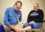 Dr. Beers checks blood flow in Elmer Stahl's legs at a free screening during Saturday's Diabetes Fair inside Penn Central Mall.