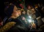 Over a dozen people took part in a Transgender Day of Remembrance vigil on Monday evening. The November winds prevented flames from lighting the candles, so participants use cellphone flashlights instead.