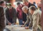 John DeRooi examines a map that outlines where a northwest bypass would go and how it may impact his ground.