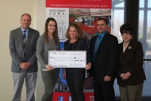 Emily Brown (middle left) and Jen Main (middle right) at a check presentation by Main Street Iowa.