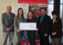 Emily Brown (middle left) and Jen Main (middle right) at a check presentation by Main Street Iowa.