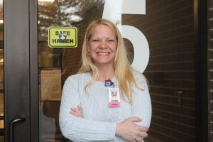 Birthing Center Director Heather Cook stands in front of one of the Safe Haven stickers located at Mahaska Health Partnership. MHP is among the health care facilities in Iowa that proudly provides Safe Haven zones. 