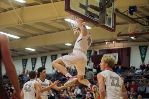 Oskaloosa's Cole Henry puts home the high-percentage shot against Washington on Tuesday night.