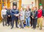 Oskaloosa Police Officer Nick Landgrebe presents a check to Big Brothers & Big Sisters Director Robbyn Duchow with a check from the funds raised during No Shave November.