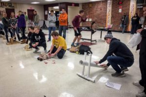 Oskaloosa High School students demonstrate ping pong ball launchers they constructed as part of the PBL Showcase.