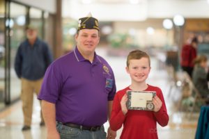 American Legion District Commander Darrin Alderson (left) and Blake Herny (right) pose with a challenge coin sent by Lt. Colonel Tanya Hildebrand.