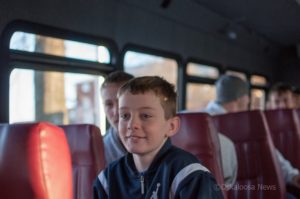 Cole Henry rides the William Penn team bus back into Oskaloosa after the team returned home from a runner-up finish in the NAIA Championship game in 2013.
