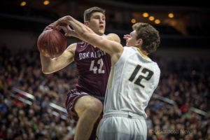 Oskaloosa's Jared Kruse drives againt Glenwood's Andrew Blum during the title game on Friday.