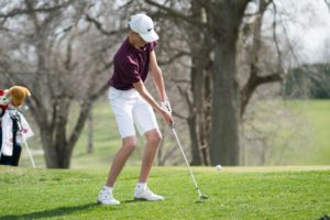 Oskaloosa's Spencer Tucker chips onto the green at Edmundson Golf.