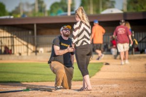 Chris Valster asks his girlfriend Shyann Fleener to marry him in between games at the Babe Ruth field on Thursday night.