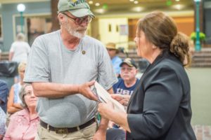 DAR member Connie Van Polen presents Kenneth Mortensen with a book and certificate at Saturday's 'A Salute To Vietnam Veterans'