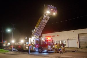 Oskaloosa Fire's Tower 6 provides needed light for firefighters as they battled a fire at Clabaugh Enterprises on Friday night. (photo by Ginger Allsup/Oskaloosa News)