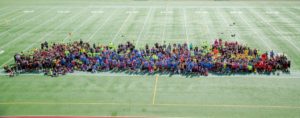 977 students and 150 faculty stop for a photo at Lacey Stadium on Tuesday. (photo by Ginger Allsup)