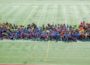 977 students and 150 faculty stop for a photo at Lacey Stadium on Tuesday. (photo by Ginger Allsup)