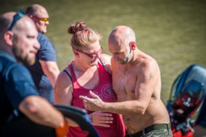Brianna Washburne hugs onto her husband Nathan Washburne after emergency personnel safely delivered him back to shore.