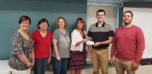 Anderson and San (right) presented a check to the Mahaska County Homelessness Coalition last week in the amount of $2039.00, money raised from a disc golf tournament.