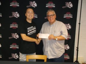 Oskaloosa Community Schools Activities Director Ryan Parker receives a $3,500 check from Oskaloosa Elks Exalted Ruler Rick Corbett. The money will be used toward the purchase of a rebounding machine for the school basketball program. (submitted photo)