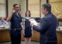 Justin DeKleine (left) was sworn is as Oskaloosa's newest police officer on Monday. Oskaloosa Mayor Dave Krutzfeldt (right) administered the oath of office. DeKleine wife, Makayla (center) pinned on her husband's badge.