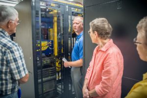 Customers tour the server room at MCG on Tuesday morning.