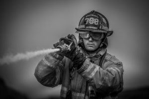 Oskaloosa firefighter Adam Haroldson battles the most recent B&B Bedding fire.