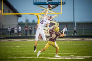 The ball sails just out of reach for Oskaloosa's Isaac Schultz against Pella Christian on Friday night.