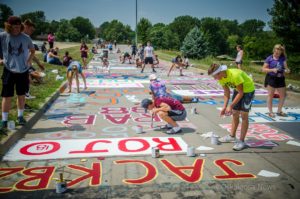 OHS Senior paint their names and numbers on 'Indian Trail' this past week. (photo by Ginger Allsup)