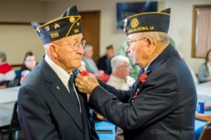 Ray "Ed" Bridges gets a little help from his brother Fred Bridges with his poppy. Veterans gathered on Sunday morning to observe Veterans Day 2018.