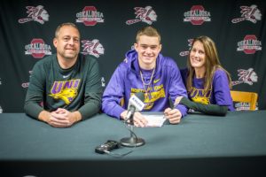 Oskaloosa's Cole Henry signed his letter of intent to play for the University of Northern Iowa Panthers, joining their basketball squad. Pictured is John Henry, Cole Henry, and Maggie Henry.