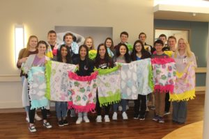 Members of the Oskaloosa High School Student Council and Mahaska Health Birthing Center Director Heather Cook (right) are shown with the baby blankets the students recently donated to the Birthing Center.  (submitted photo)