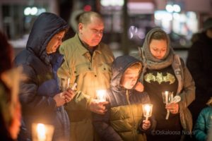 Angelia (blue coat left) and Robert Fogle (center) at a candlelight vigil for their son David Fogle.