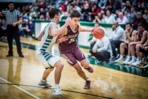 Rian Yates drives past the Pella defender on Friday night in Pella.