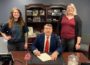 Mayor David Krutzfeldt (center) signs the proclamation for Sexual Assault Awareness Month on Thursday, March 21. He is joined by Crisis Intervention Services Sexual Assault Advocate Hailey Brown (left) and Sexual Assault Prevention Specialist Erin Weber (right).