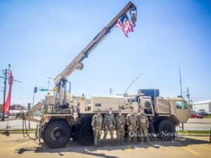 Members of Det 2 3654th Maintenance Company stand by their HEMTT A4 M984A4 Recovery Truck on Saturday as a way of reaching out to the Oskaloosa community.