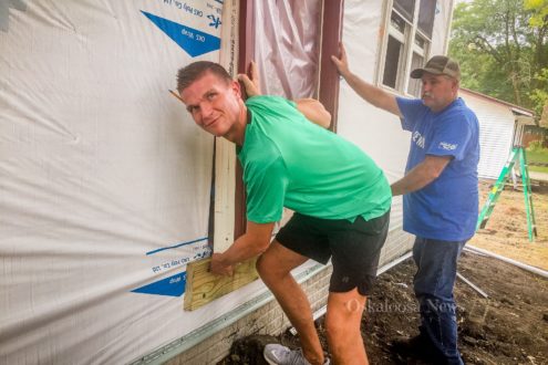 Ben Peiffer and Clow Valve volunteer Rick Flattery work to install a door on one of the new Habitat for Humanity homes this past week.