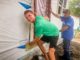Ben Peiffer and Clow Valve volunteer Rick Flattery work to install a door on one of the new Habitat for Humanity homes this past week.