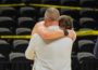 Coach John Henry (front) hugs Senior Eddie Daley after the loss to Carroll on Friday night.